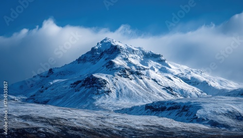 Wallpaper Mural Snow-covered mountain with a cloudy blue sky in a vast landscape Torontodigital.ca