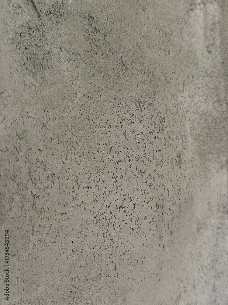 Fototapeta premium Close-up of textured concrete surface displaying unique patterns and colors, perfect for use in backgrounds, design projects, and creative applications with copy space