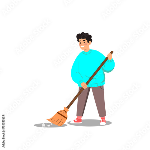 Happy young man in a turquoise sweater sweeping the floor with a broom, doing household chores with a smile on a white background