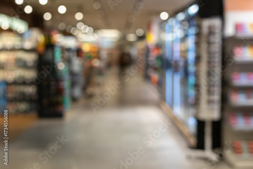 Wallpaper Mural long, out-of-focus shot of a bright shopping mall or large store aisle, with abstract figures and product displays. represents consumption, retail, and commerce Torontodigital.ca
