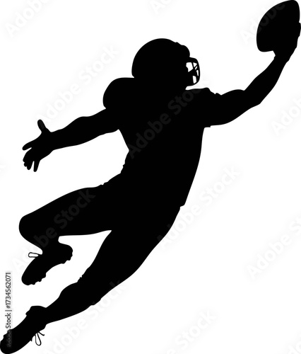 Silhouette of a American football player jumping high catching ball