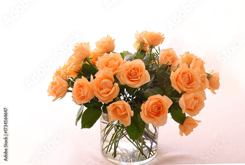 Bouquet of roses in a glass vase on a white background.