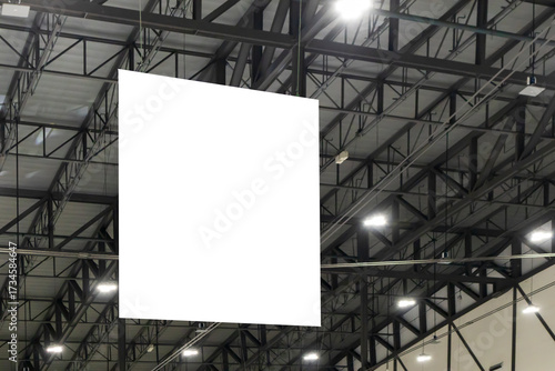 Large mockup of a sign hanging from the ceiling of the hall for displaying work, graphics and various forms of media.