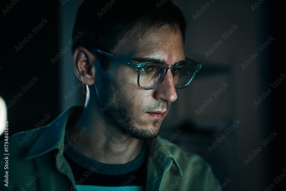 Obraz premium Caucasian web developer and IT support specialist coding in dark office, working on cybersecurity, hacking prevention and cloud computing.