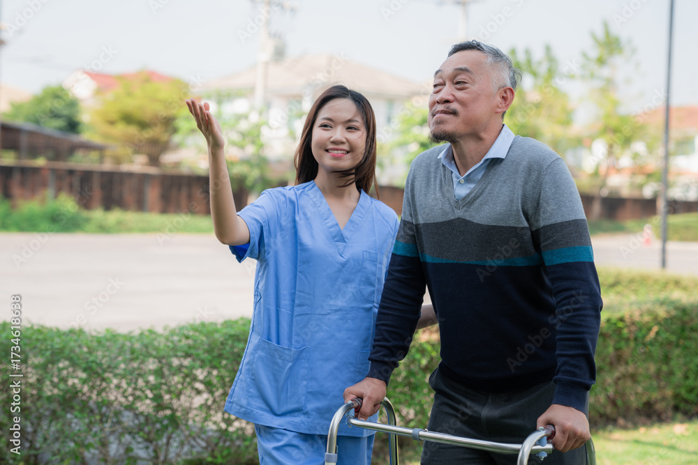 Obraz premium Senior man in wheelchair enjoying outdoor time with family and caregiver nurse, symbolizing elderly care, support, healthcare, nursing service, and happy retirement life.