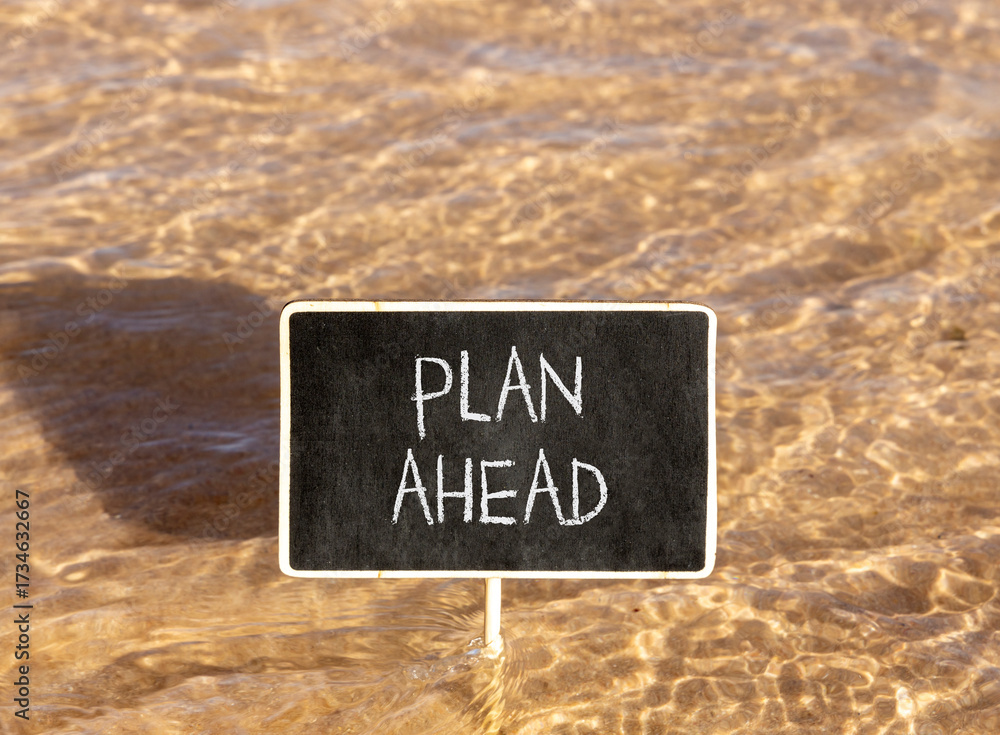 Naklejka premium Plan ahead symbol. Concept word Plan ahead on beautiful black blackboard. Beautiful Red sea water background. Black blackboard. Business plan ahead concept. Copy space.