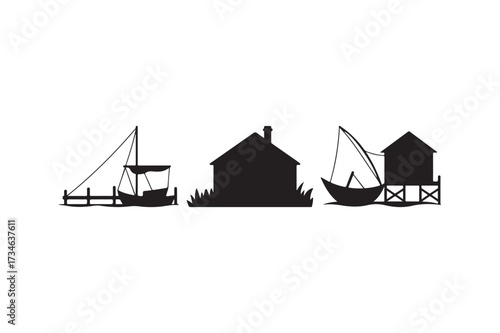 Silhouette of a coastal village with boats and buildings