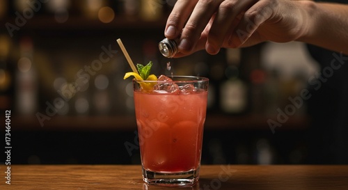 Close-up of bartender hand secretly adding substance to drink, concept of drink tampering and danger