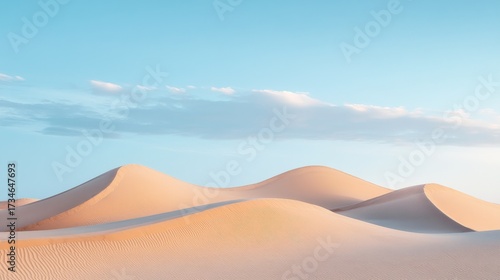 Fototapeta Naklejka Na Ścianę i Meble -  A calming desert desktop wallpaper with soft sand dunes and a blue sky 