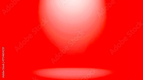 Bright spotlight illuminating a stage floor with a warm red background and soft light spill