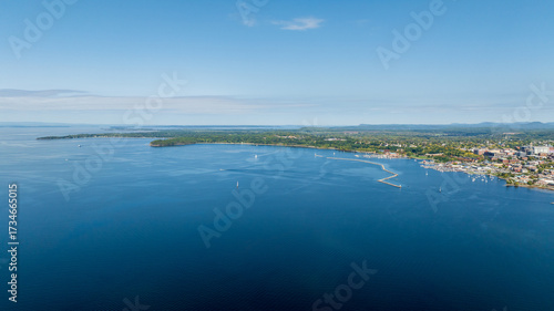 Aerial view of Burlington, Vermont with Lake Champlain's blue waters and marina stretching into the distance.