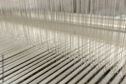 Tapeta Modern jacquard loom heddles and warp threads in textile manufacturing