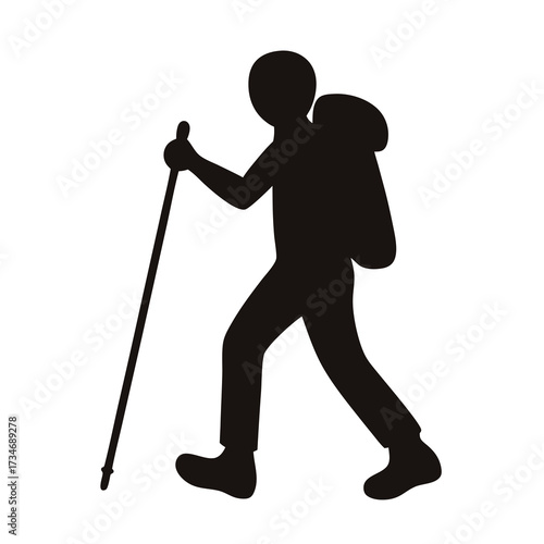 Silhouette of a hiker with a backpack and walking stick outdoors