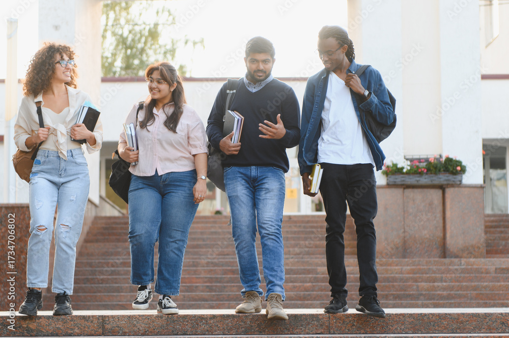 Obraz premium Diverse students walking down university stairs together