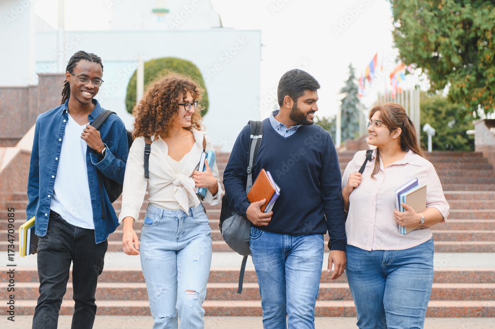 Obraz premium Diverse university students walking on campus stairs