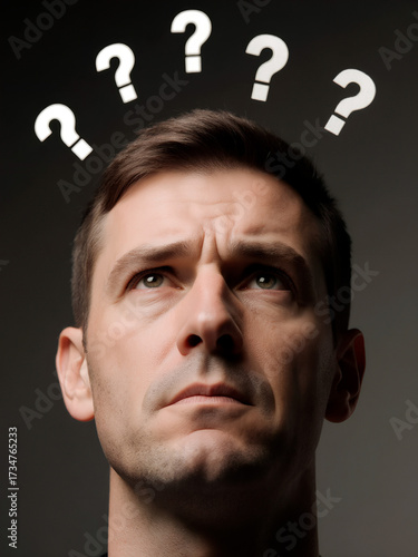 Man with question marks above his head, thinking about something.