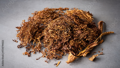 Dry Tobacco Leaves Prepared For Rolling Cigarettes On A Gray Surface