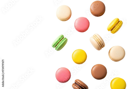 Overhead shot of vibrant green, pink, yellow, chocolate, beige French macarons with colorful sprinkles on white background, copy space left, macro detail. Concept of sweet indulgence