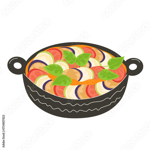 Ratatouille in a black oval pan with basil leaves