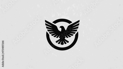 Stylized black eagle with outstretched wings in a circular emblem on clean white. Modern powerful bird of prey symbol graphic design.