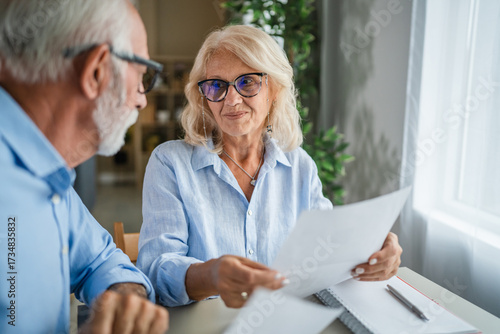 Senior couple discussing finances and retirement planning at home