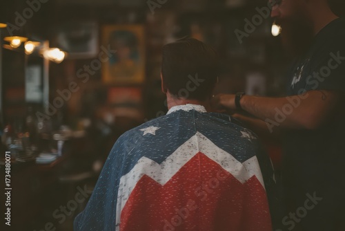 Styling client’s hair in a barbershop while wearing an American flag cape, celebrating diverse professions and patriotism in the USA
