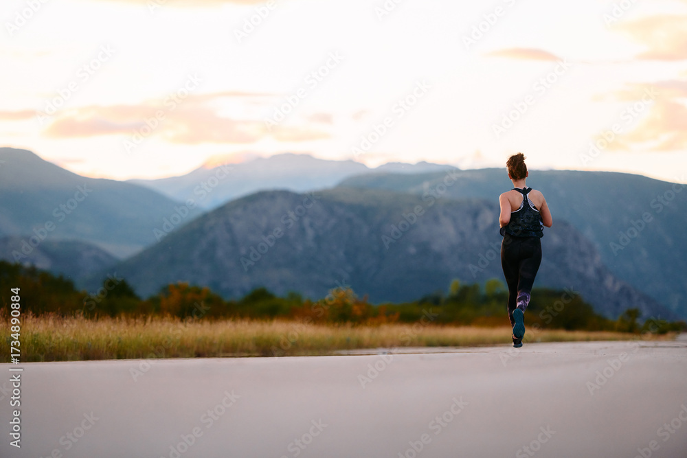 Fototapeta premium Determined Athlete Running in the Sun amidst Beautiful Nature