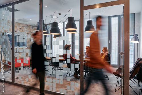 Fotografie In the dynamic hustle and bustle of a business environment, a group of young bus