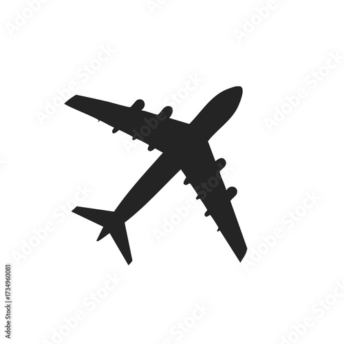 Black silhouette of a large four engine passenger airplane flying overhead