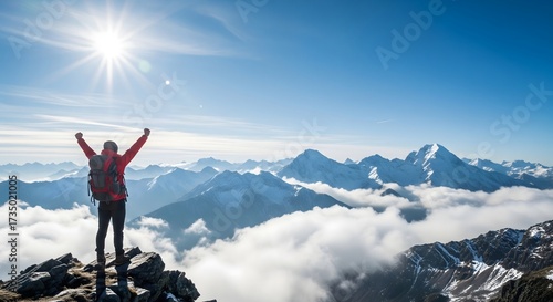 Hiker celebrating victory on snowy mountain peak, adventure travel success, achievement and freedom concept with sunlight, blue sky, and panoramic view of majestic alpine mountain landscape.