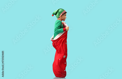 Young boy in elf costume an...