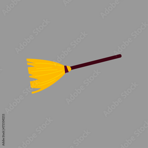 Yellow Broom with Brown Handle on a Solid Grey Background - Halloween Witch's Cleaning Tool