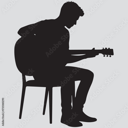 Silhouette of a young man sitting on a chair and playing an acoustic guitar on a white background