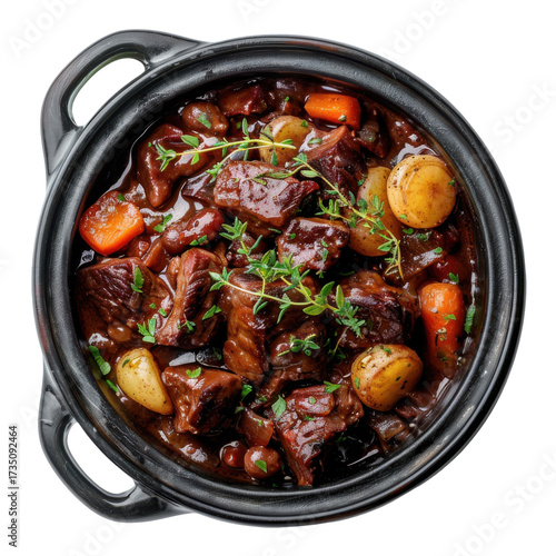 Hearty beef bourguignon in cast iron pot with thyme garnish, overhead view isolated on white background