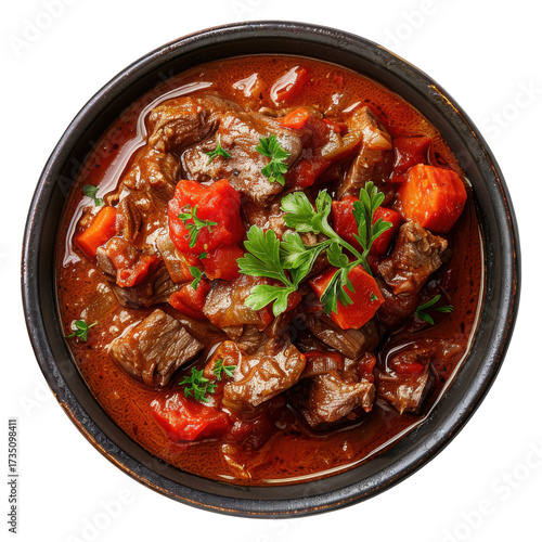 Rich beef stew with carrots and tomatoes in rustic bowl isolated on white background