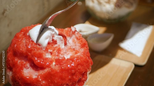 pov close up to japanese style shaved ice kakigori while use spoon to eat japanese dessert in local japanese style cafe,japanese dessert for summer time