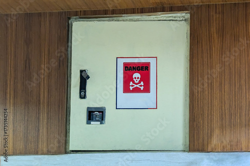 Danger warning sign on a utility box or cabinet, indicating a potential hazard