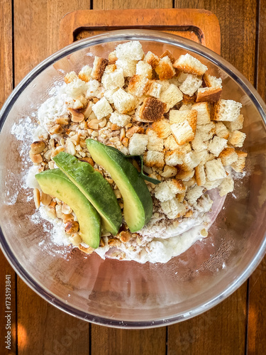 Wallpaper Mural Refreshing Indonesian iced dessert "Es Campur" served in a glass bowl with avocado, jelly, bread cubes, and shaved ice. A colorful tropical treat perfect for hot days. Torontodigital.ca
