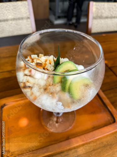 Wallpaper Mural Refreshing Indonesian iced dessert "Es Campur" served in a glass bowl with avocado, jelly, bread cubes, and shaved ice. A colorful tropical treat perfect for hot days. Torontodigital.ca