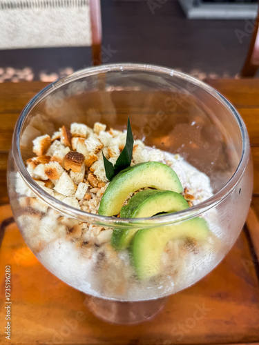 Wallpaper Mural Refreshing Indonesian iced dessert "Es Campur" served in a glass bowl with avocado, jelly, bread cubes, and shaved ice. A colorful tropical treat perfect for hot days. Torontodigital.ca