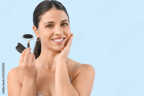 Young woman with facial mas...