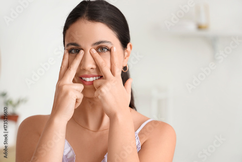 Young woman doing face buil...