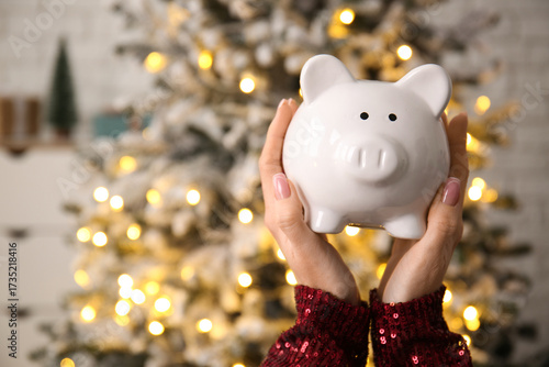 Woman holding piggy bank ag...