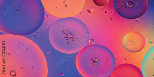 Abstract colorful oil and water bubbles with a vibrant pink and purple gradient background, macro photography