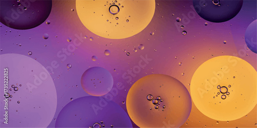 Closeup view of colorful oil and water droplets creating abstract shapes on a purple and orange gradient background