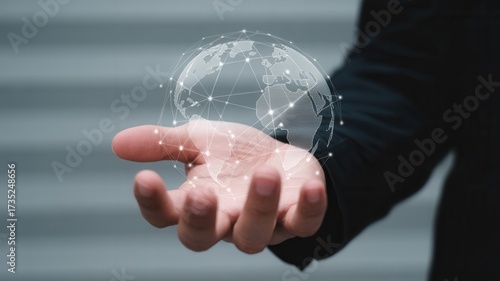 Professional businessman holds glowing digital earth network in hand, symbolizing global connectivity and future technology innovation.