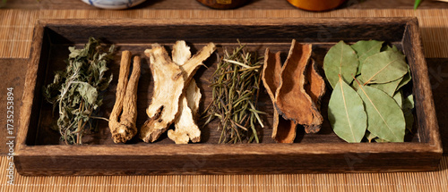 traditional Chinese herbal medicine displayed on wooden tray with dried plants, roots and leaves, natural healing, holistic health, wellness concept, apothecary style.Generated by AI