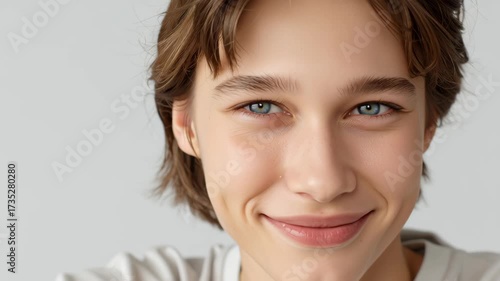 Young Person Smiling with Light Background and Soft Expression