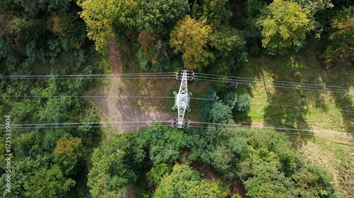 Aerial Drone View of High-Voltage Power Line Tower in Forest Landscape