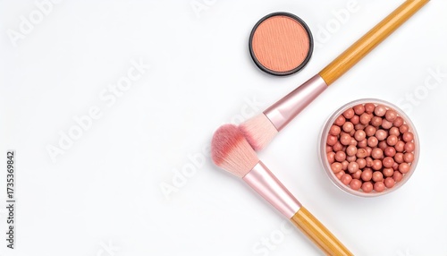 Blush, brushes, and balls on white. Delicate beauty setup